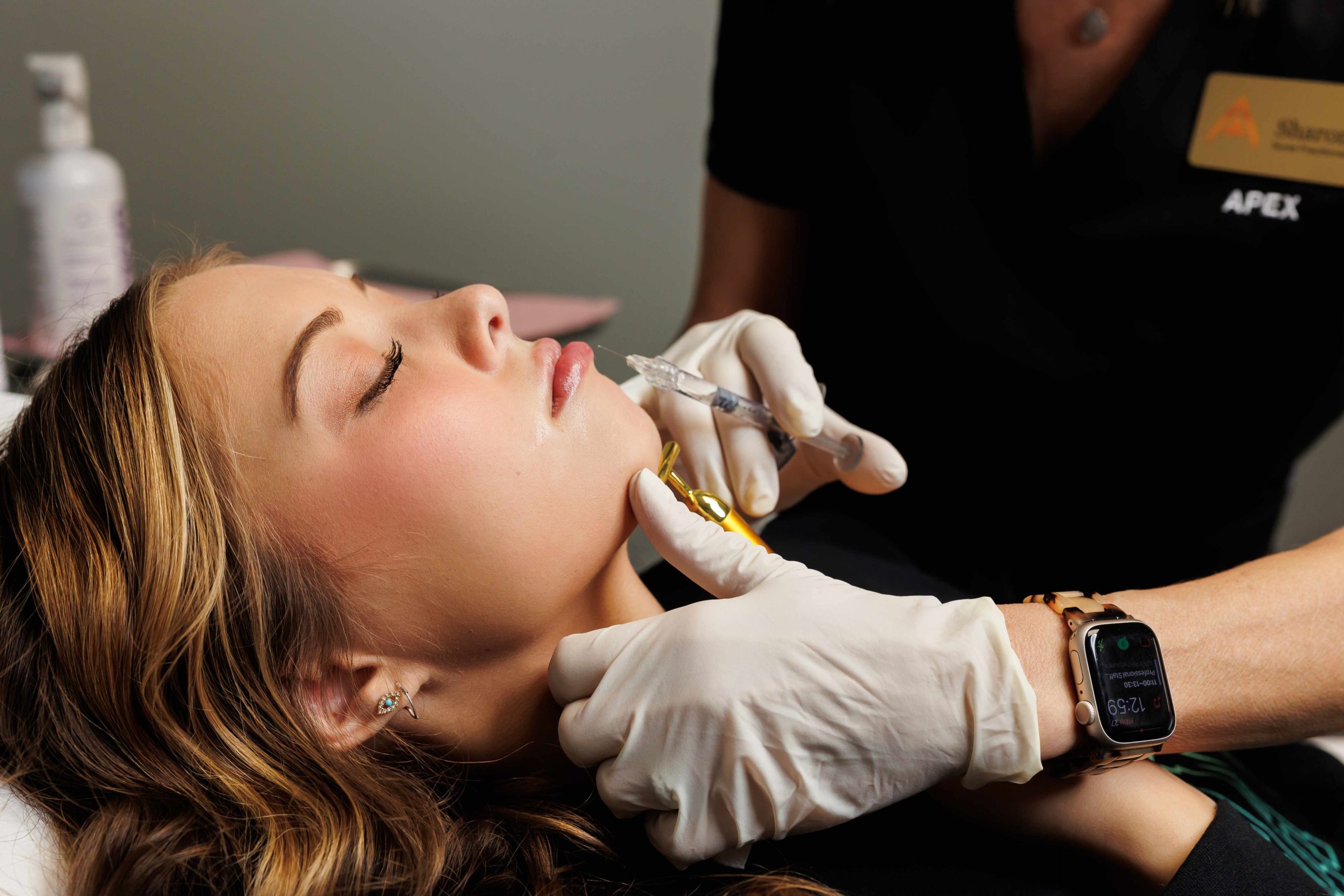 Woman having lip injections, a prick of a syringe for the beauty lips. Lip augmentation | APEX Performance & Aesthetics in Sandy, UT