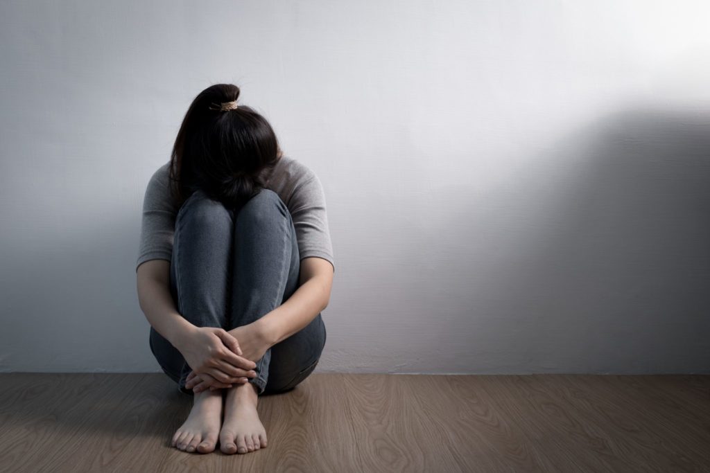 Depression woman sit on floor | APEX Performance & Aesthetics in Sandy, UT