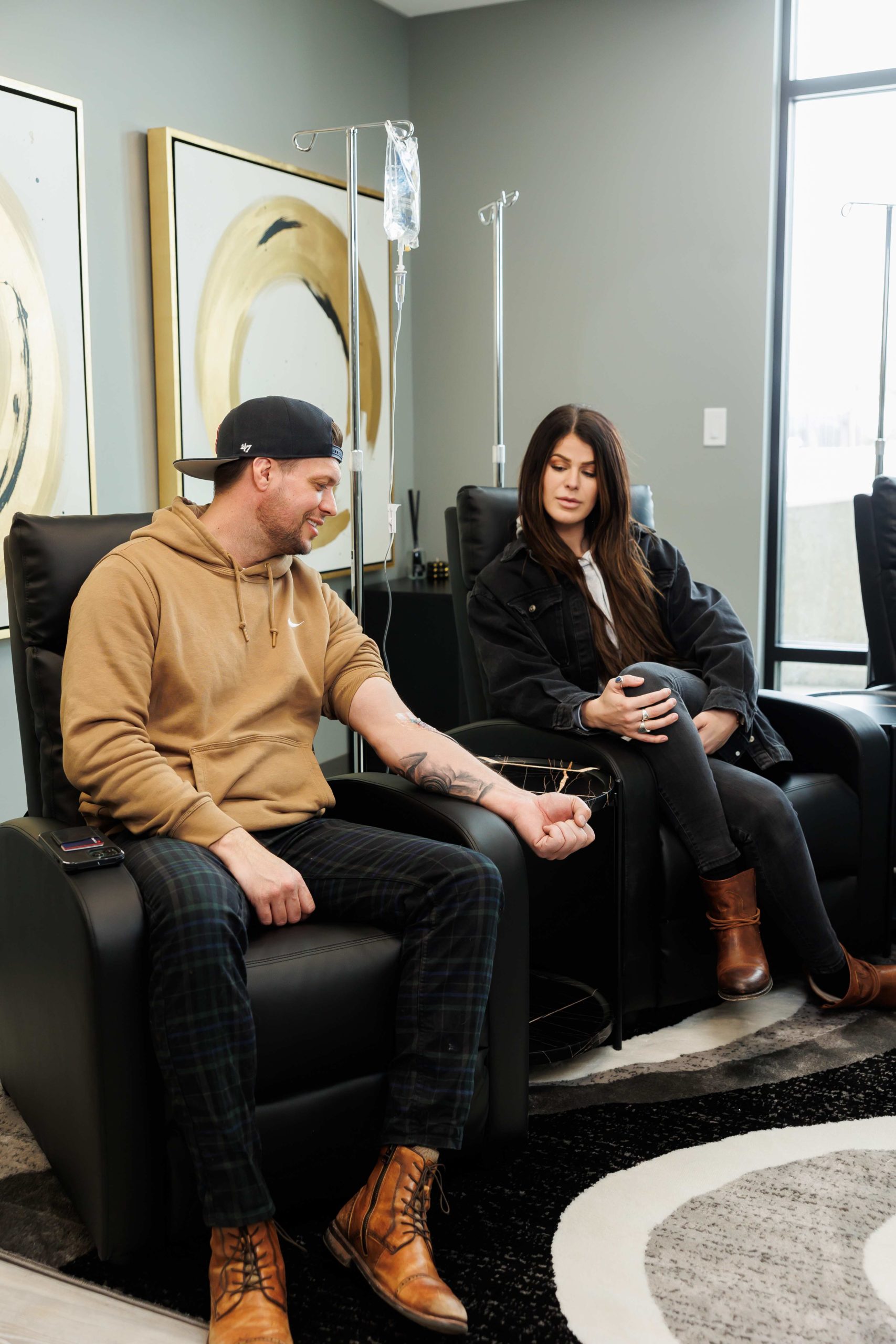 Maintenance and restoration of human immune system with vitamin IV infusion therapy. Beautiful woman with her boyfriend in modern wellness center during intravenous vitamin therapy | APEX Performance & Aesthetics in Sandy, UT